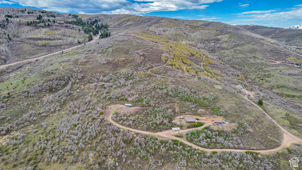 Aerial view of property and surrounding area with a mountainous background