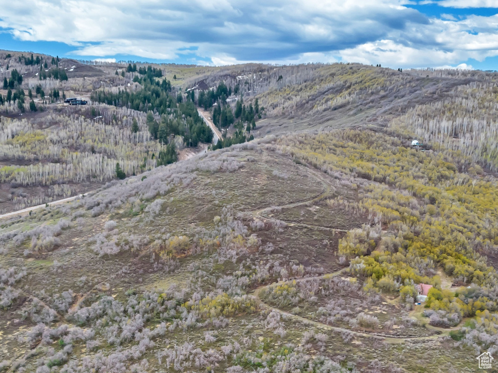 Aerial view of property and surrounding area with mountains