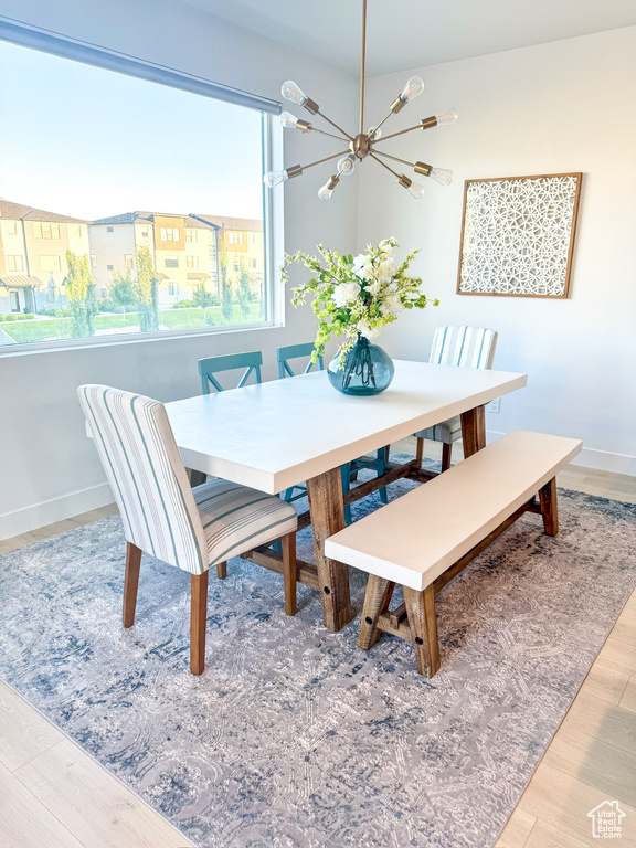 Dining space with a chandelier and wood finished floors