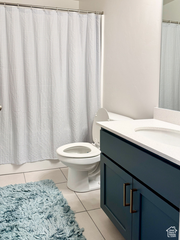 Bathroom featuring vanity, tile patterned floors, and shower / bathtub combination with curtain