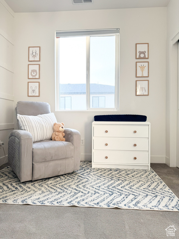 Sitting room featuring carpet floors and baseboards