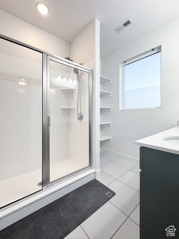 Full bath featuring a shower stall, tile patterned floors, and vanity