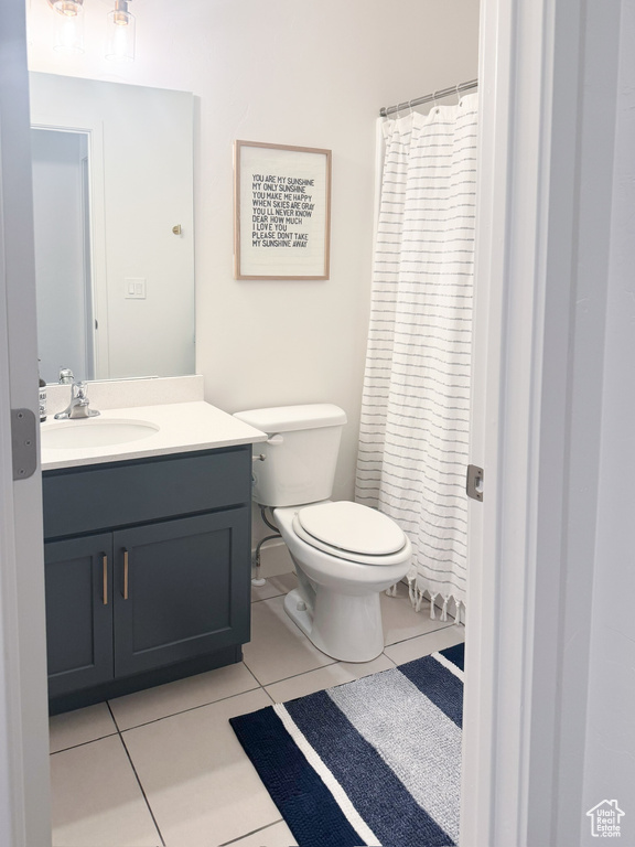 Full bathroom with tile patterned flooring, vanity, and a shower with curtain