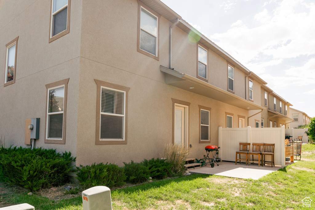 Rear view of property featuring a patio area and stucco siding
