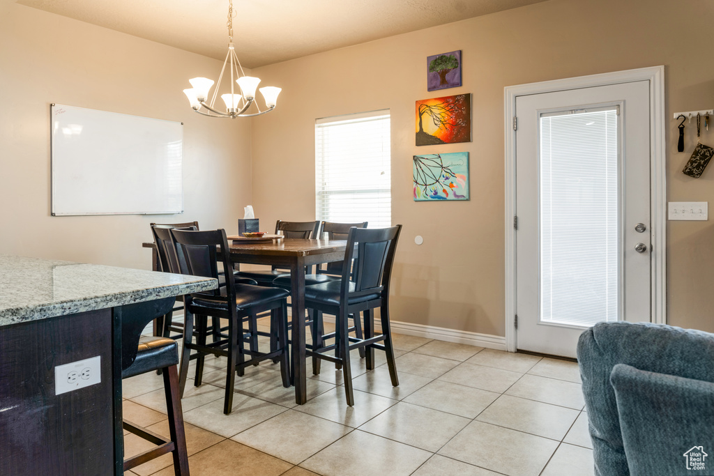 Dining room featuring a chandelier and light tile patterned floors