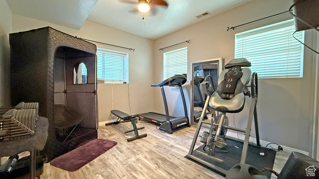 Workout area featuring wood finished floors and a ceiling fan