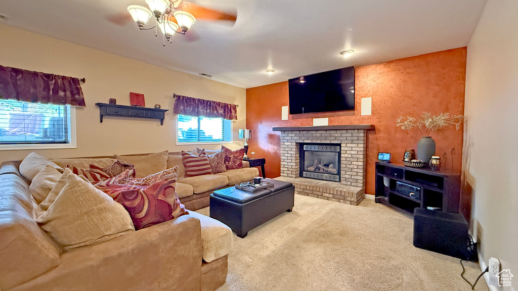 Living room with a ceiling fan, carpet, and a fireplace
