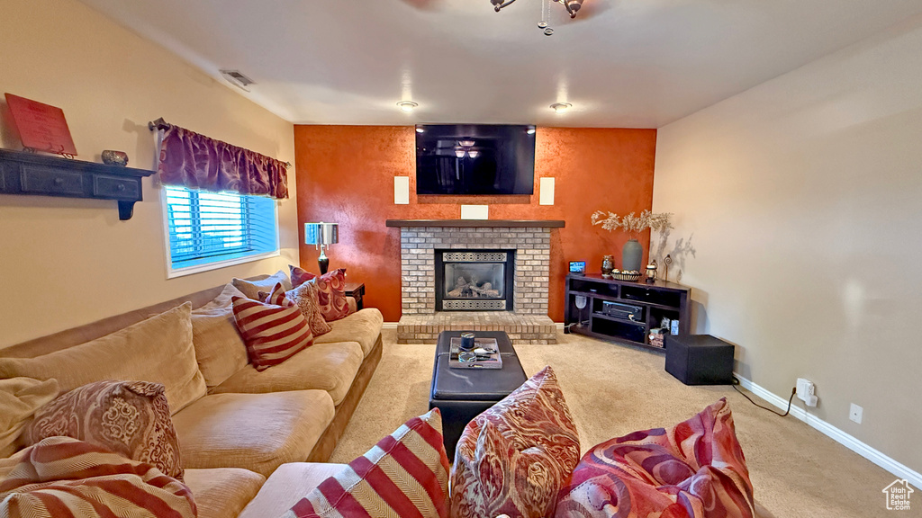 Living room with carpet flooring and a fireplace
