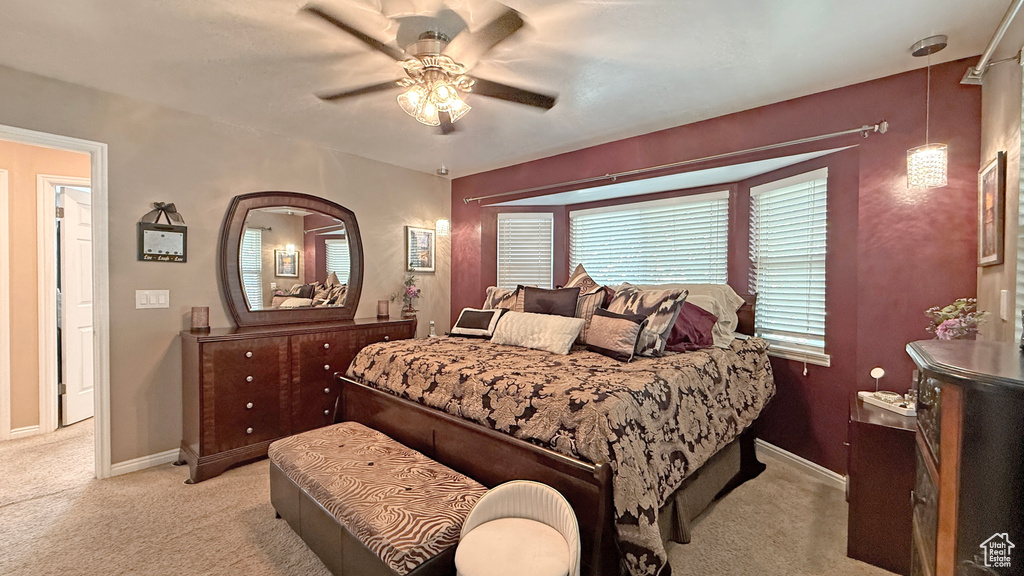 Bedroom with light colored carpet and ceiling fan