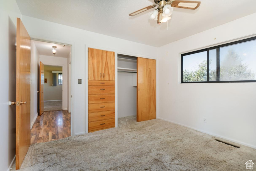 Unfurnished bedroom with a closet and carpet flooring