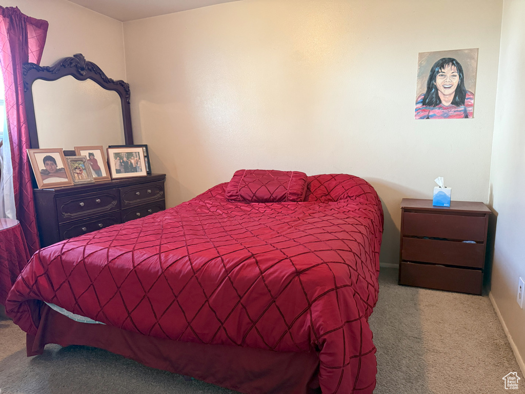 Bedroom featuring carpet floors and baseboards
