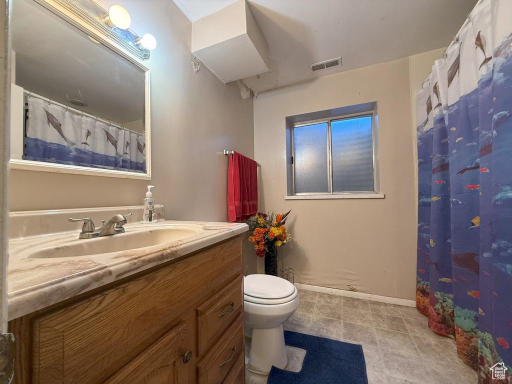 Full bathroom with vanity, tile patterned flooring, and curtained shower