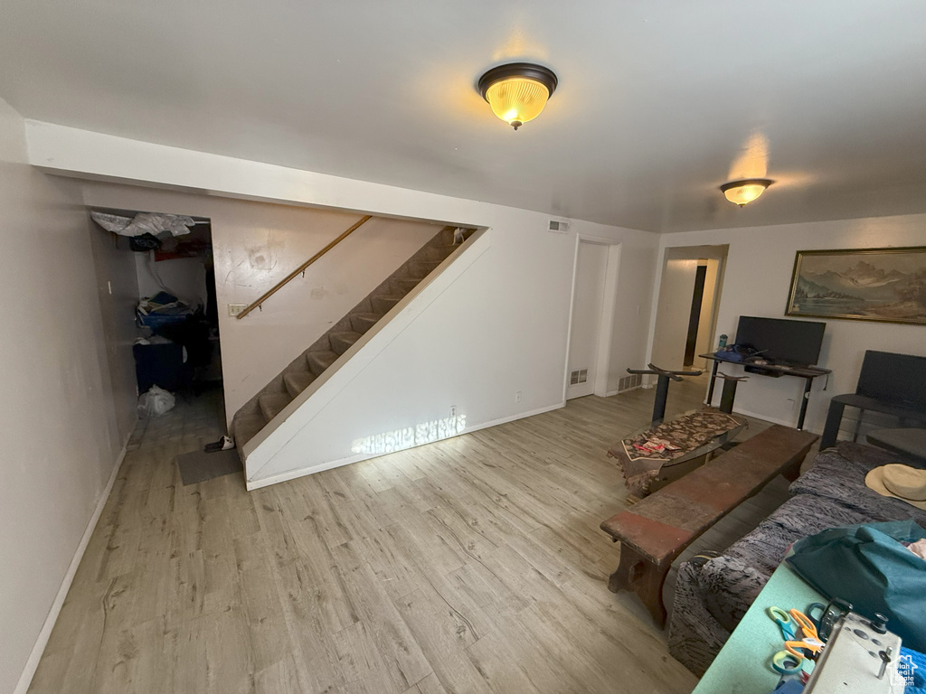 Living area with stairs and wood finished floors