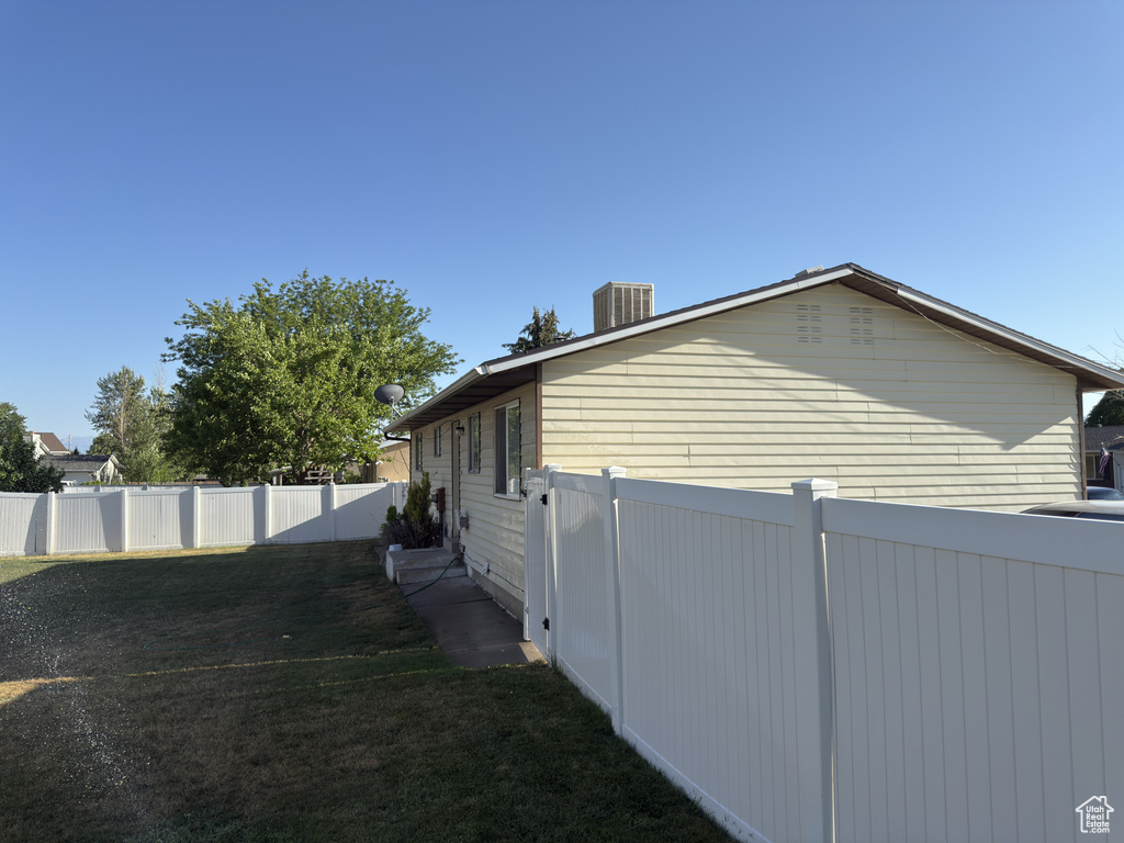View of side of home with a cooling unit