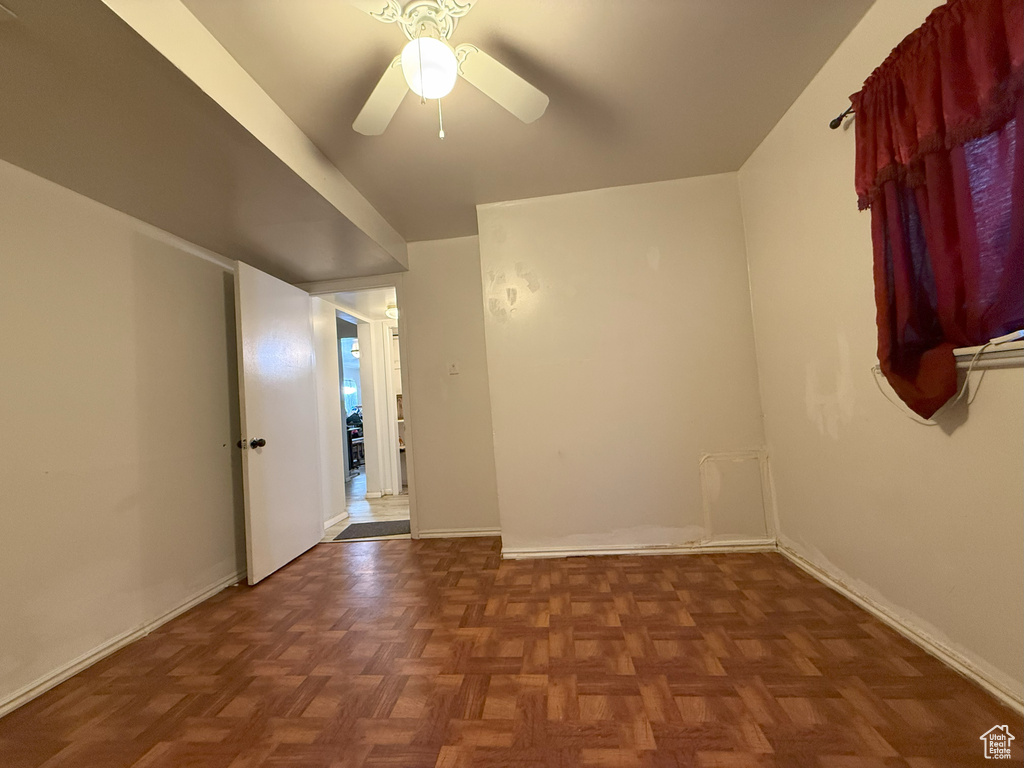 Spare room featuring ceiling fan and baseboards