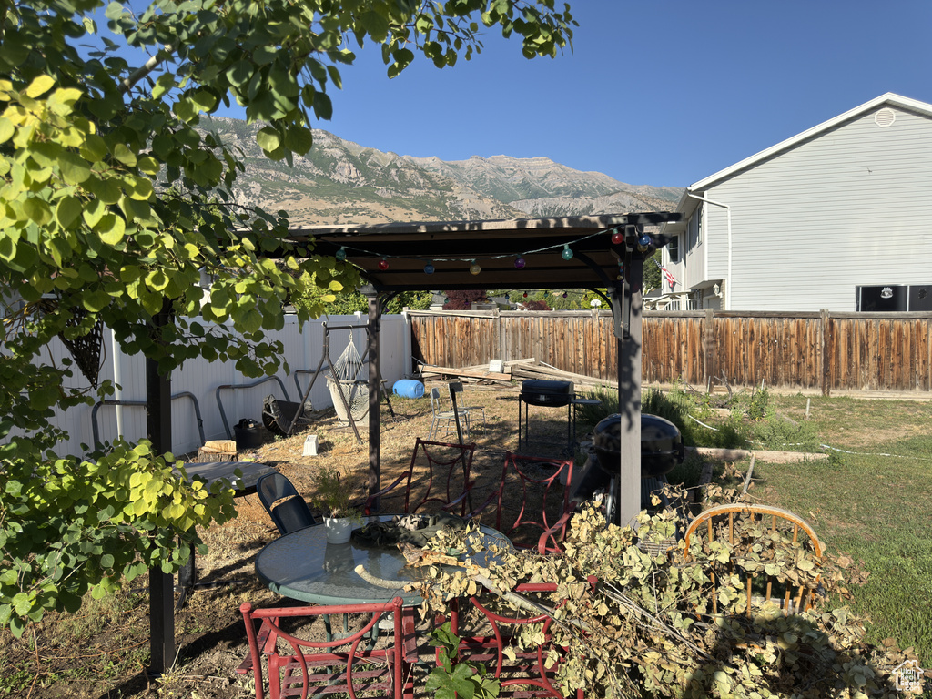 Fenced backyard with a mountain view and a gazebo