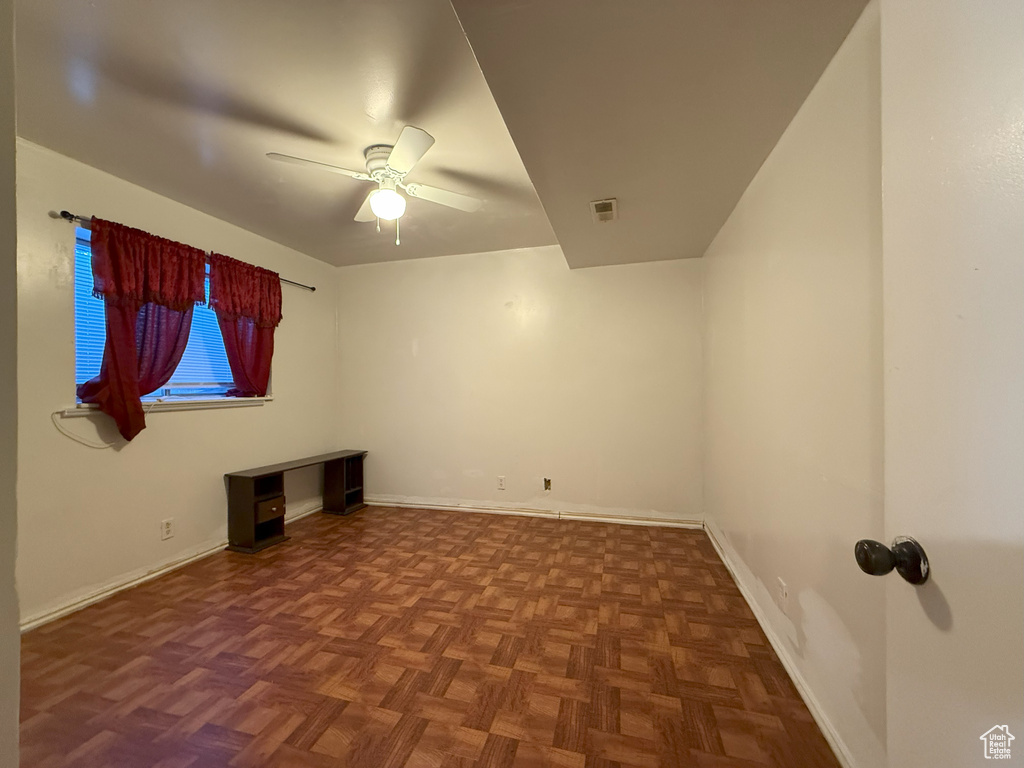 Unfurnished room with a ceiling fan and baseboards