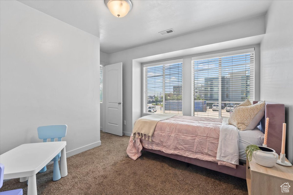 Carpeted bedroom featuring baseboards