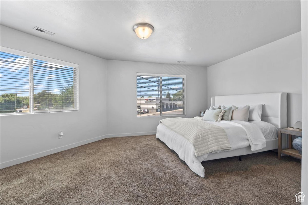 Carpeted bedroom featuring baseboards