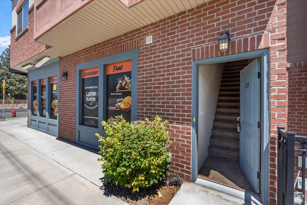 Doorway to property with brick siding