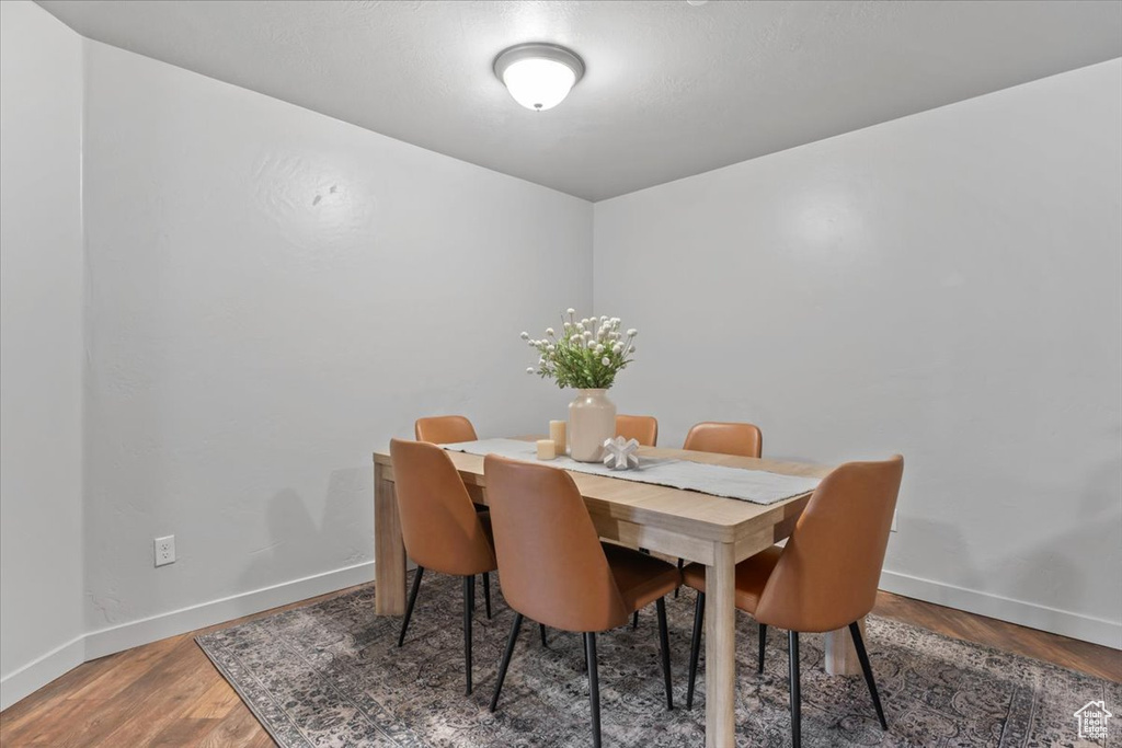Dining space with baseboards and wood finished floors