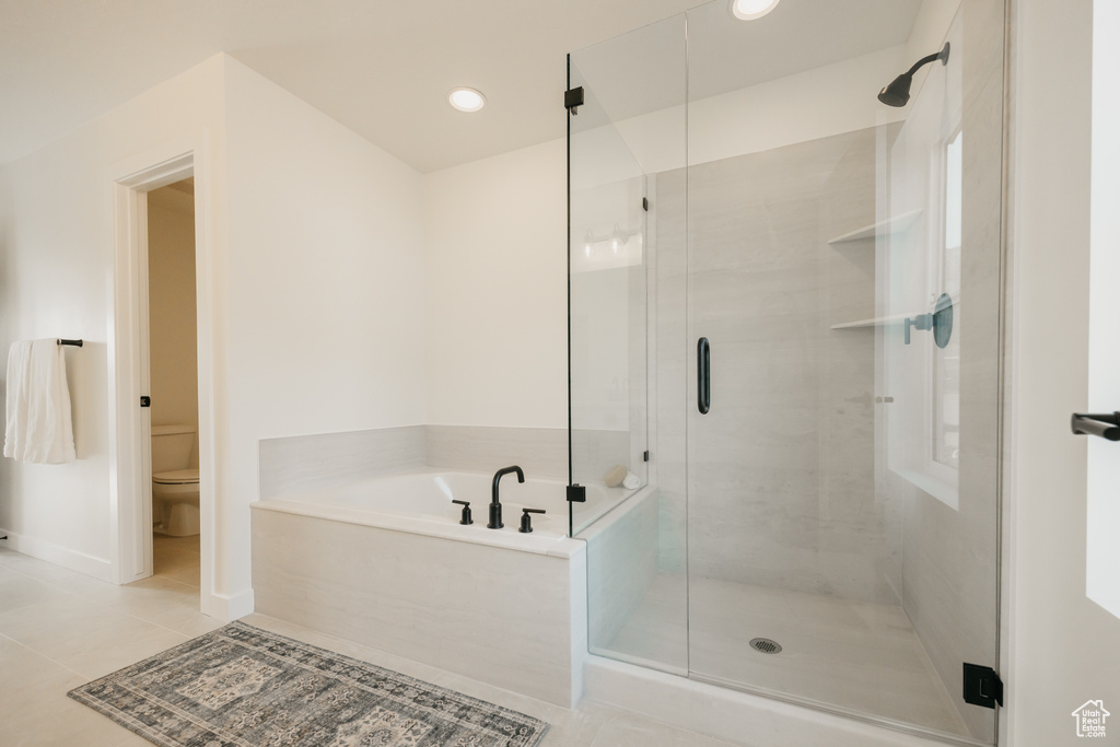 Bathroom with a garden tub, a stall shower, tile patterned flooring, and recessed lighting