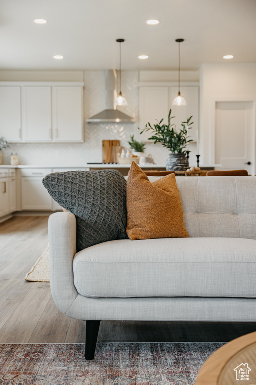 Living area featuring light wood-style floors and recessed lighting