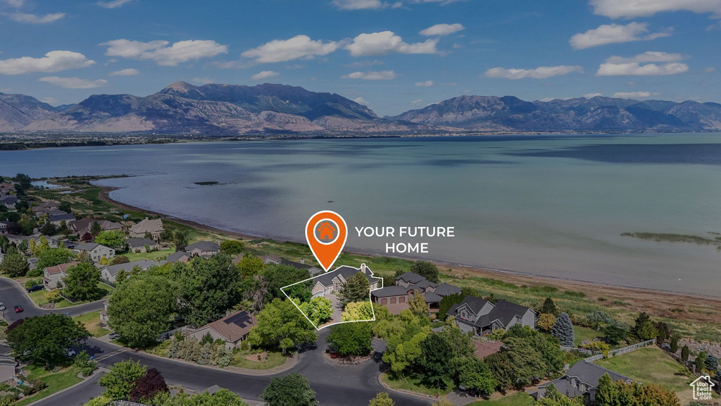 Aerial view of residential area with a water and mountain view and property parcel outlined