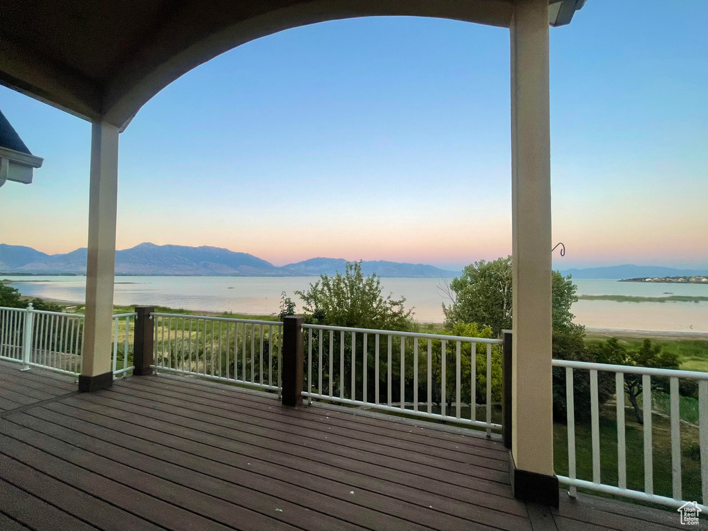 Wooden deck with a water and mountain view