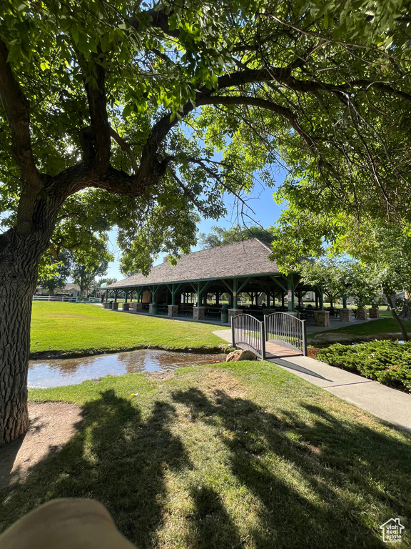 Surrounding community with a yard and a water view
