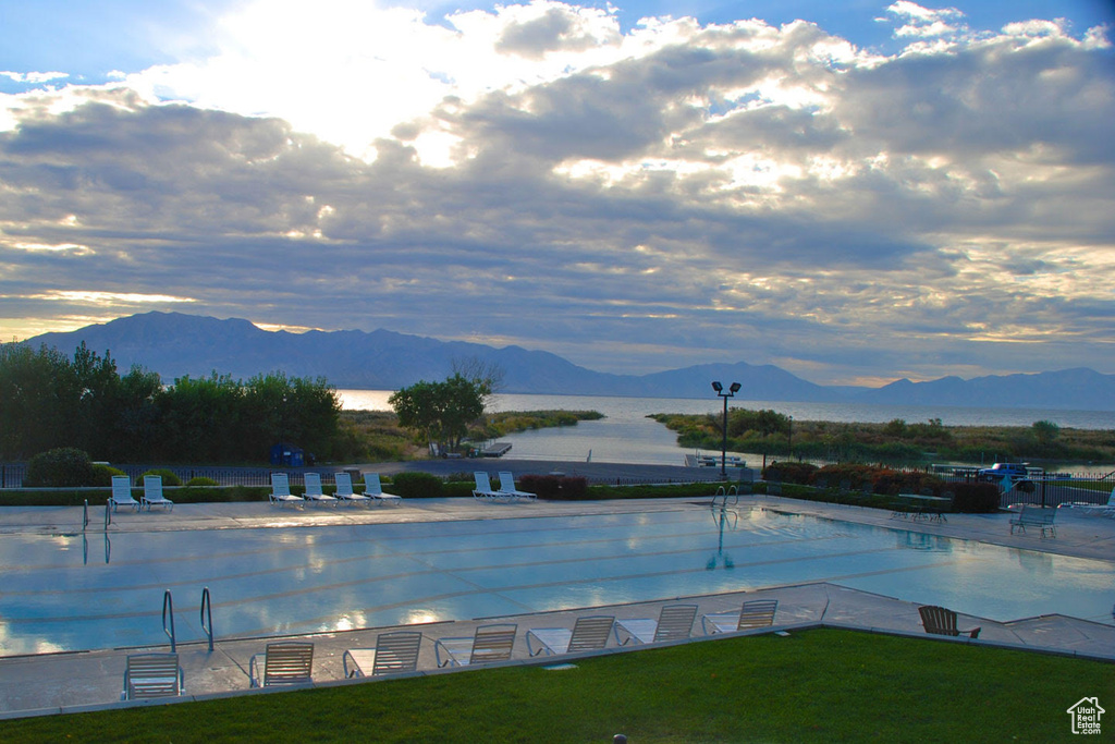 Community pool with a water and mountain view