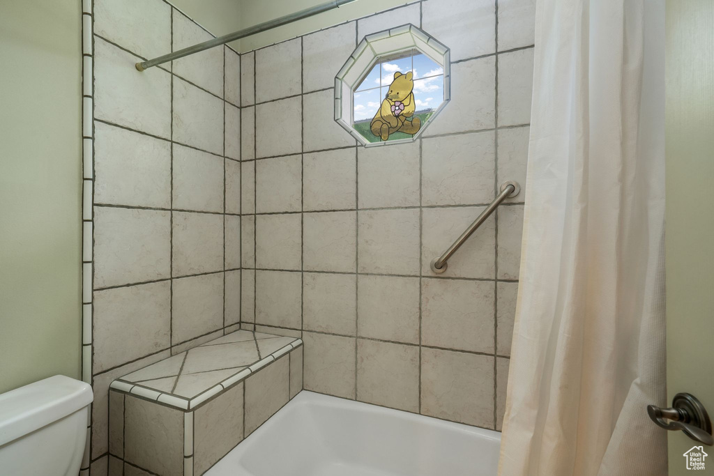 Bathroom with toilet and shower / tub combo