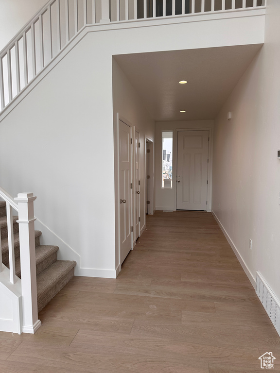 Entrance foyer featuring light wood-style flooring, stairway, and recessed lighting