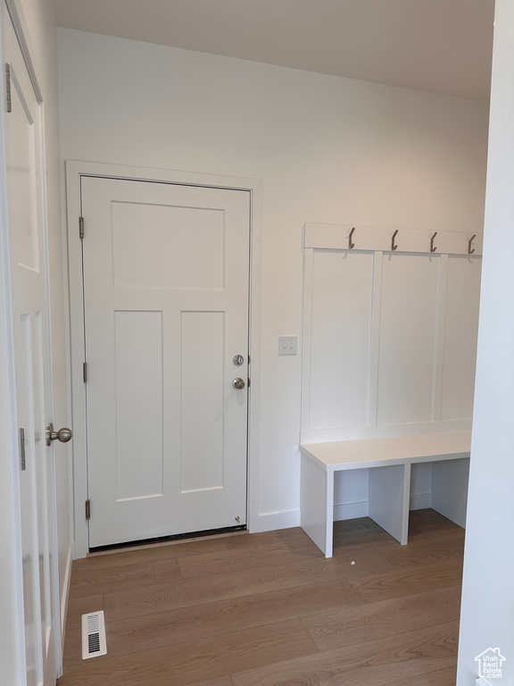 Mudroom with light wood-type flooring and baseboards