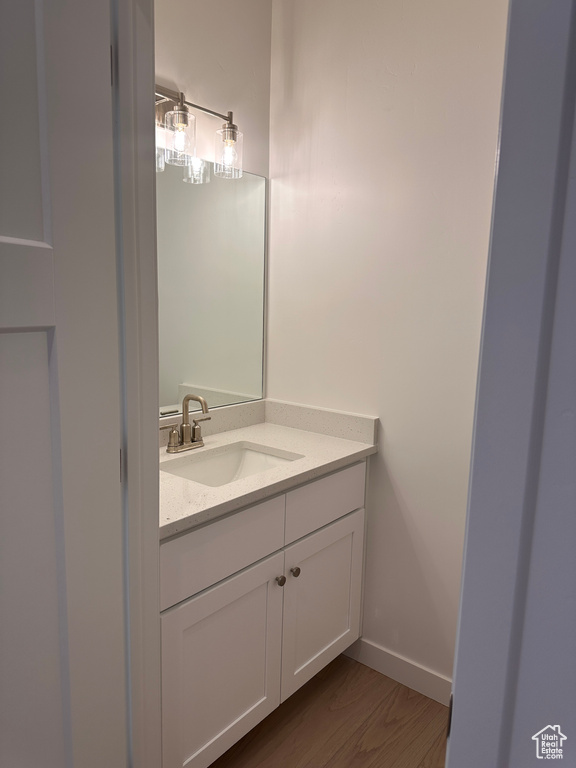 Bathroom with vanity and wood finished floors