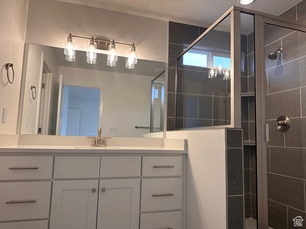 Bathroom featuring a stall shower and vanity