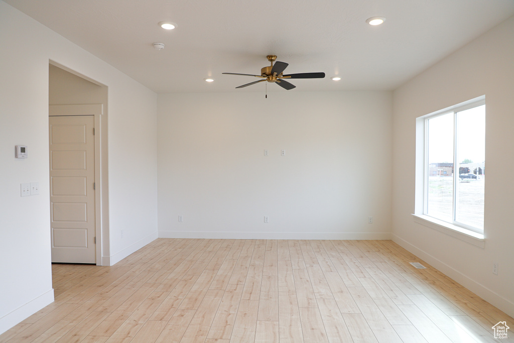 Spare room featuring recessed lighting, a ceiling fan, and light wood-style flooring
