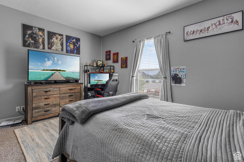 Carpeted bedroom featuring baseboards