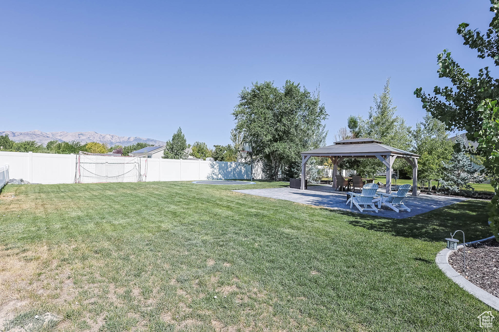 View of yard featuring a gazebo, a mountain view, and a patio