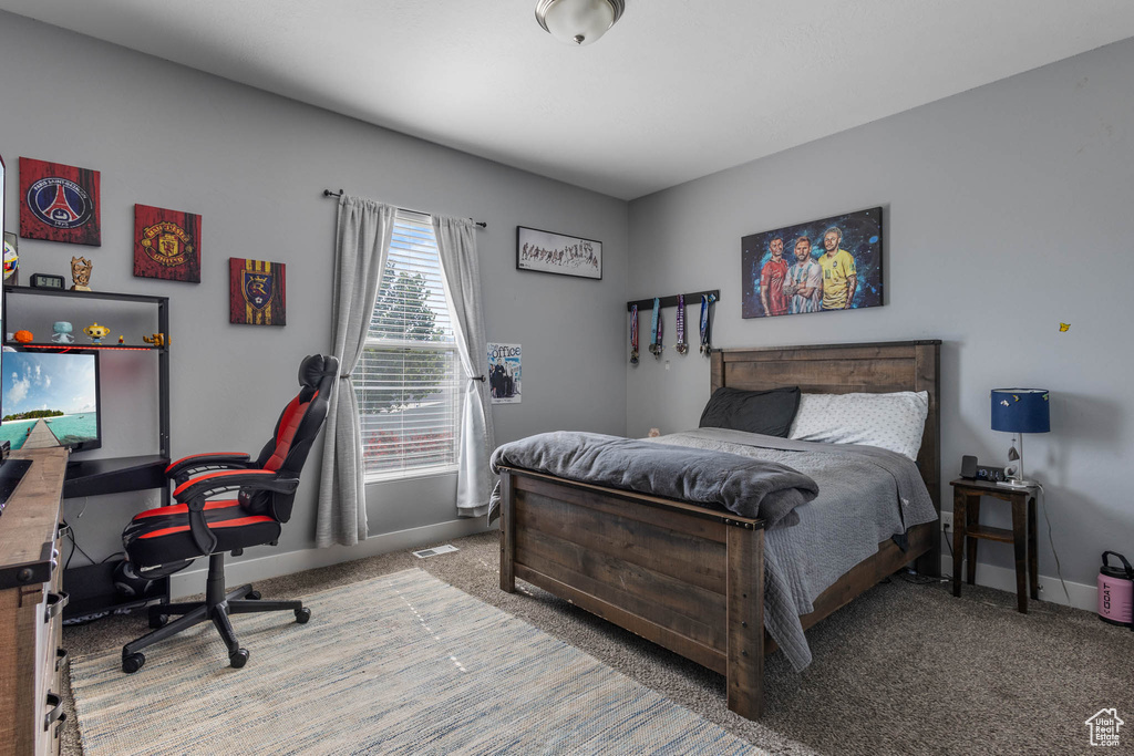 Carpeted bedroom featuring baseboards