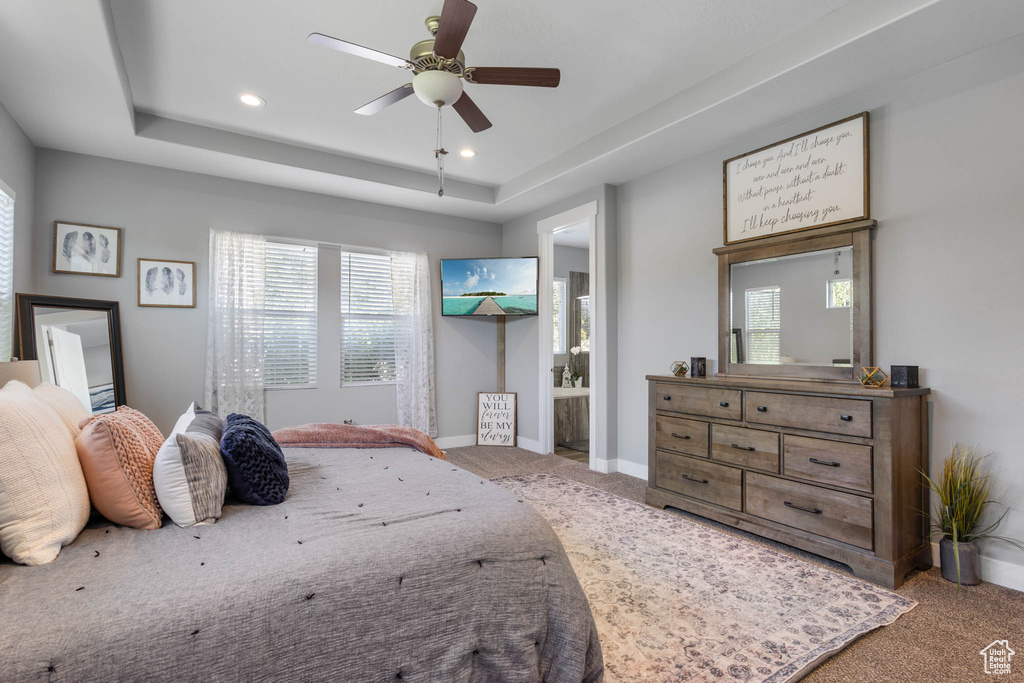 Bedroom featuring carpet, multiple windows, a raised ceiling, recessed lighting, and ceiling fan