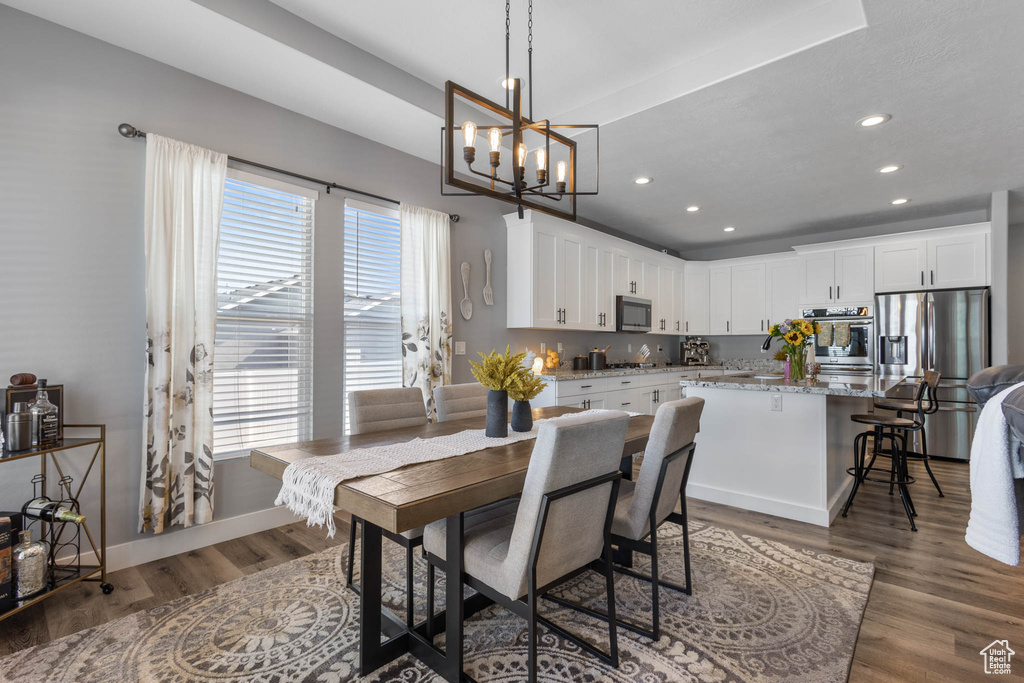 Dining space featuring a chandelier, recessed lighting, and wood finished floors