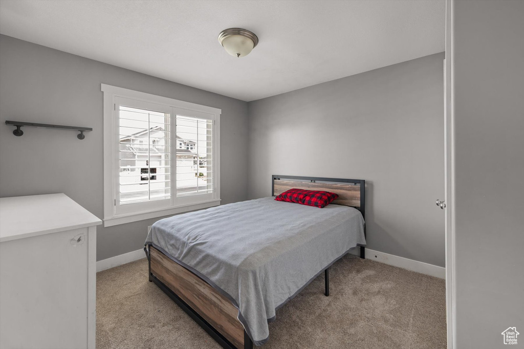 Carpeted bedroom with baseboards