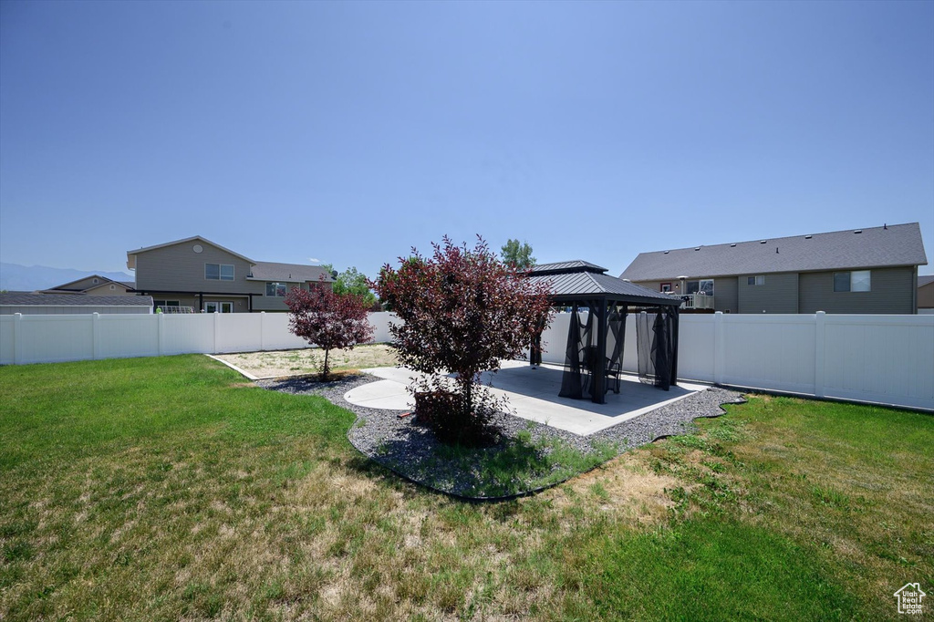 Fenced backyard with a gazebo and a patio