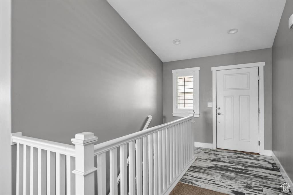 Entrance foyer featuring baseboards and wood finished floors