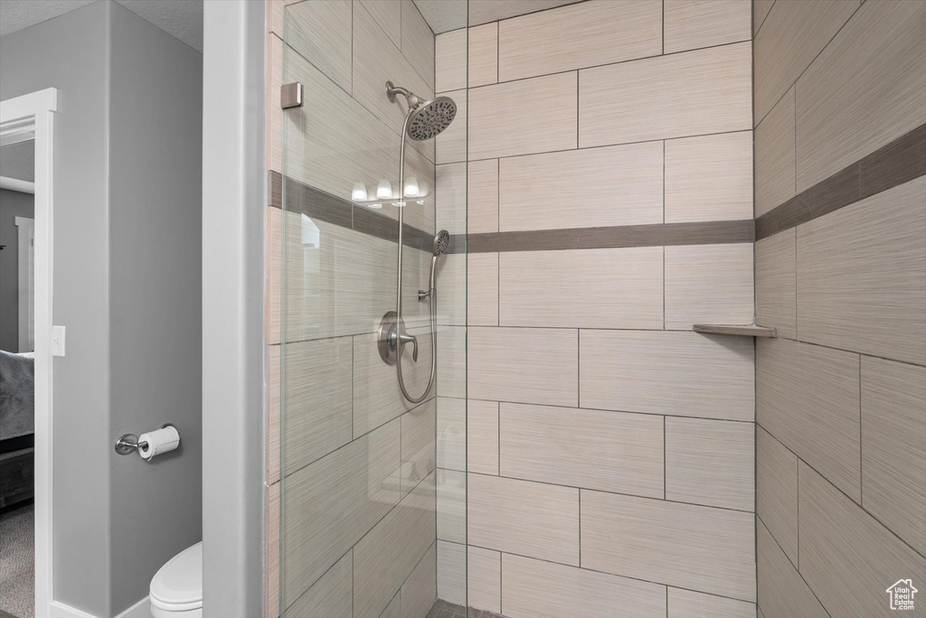 Full bathroom with a stall shower and toilet