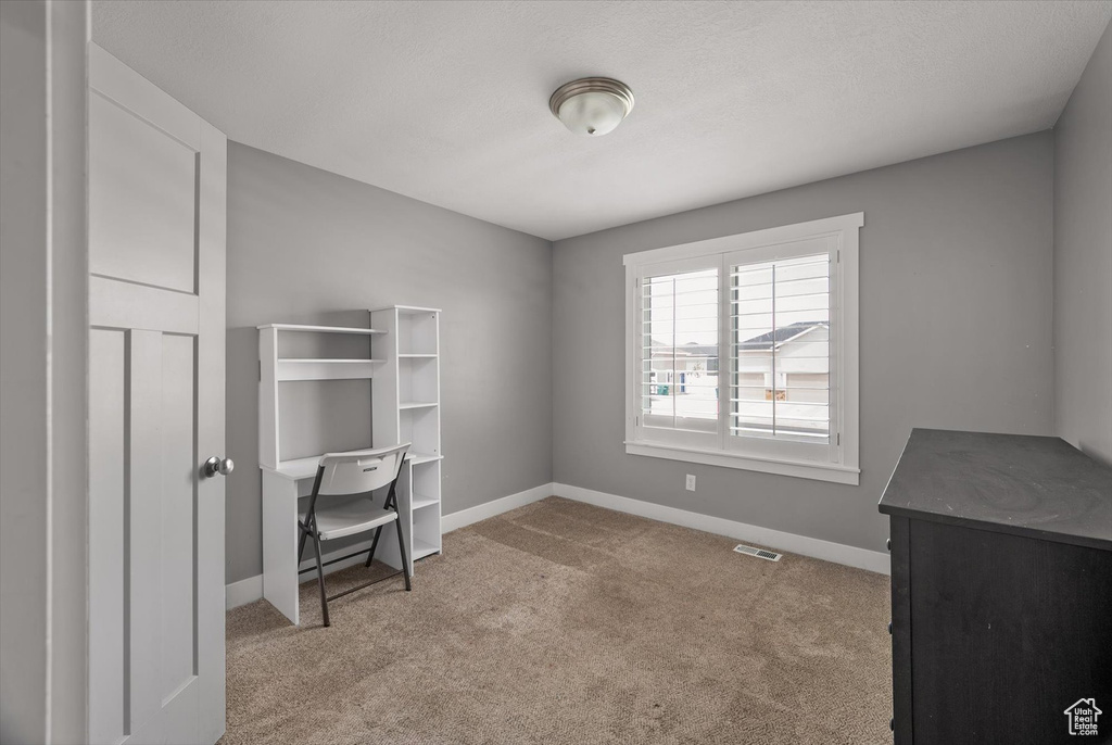 Unfurnished office with carpet and baseboards