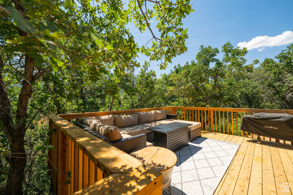 Deck with an outdoor hangout area and a grill