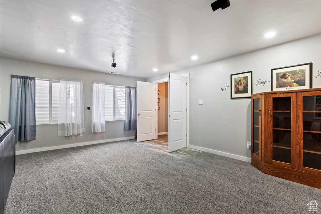 Unfurnished living room featuring carpet and recessed lighting