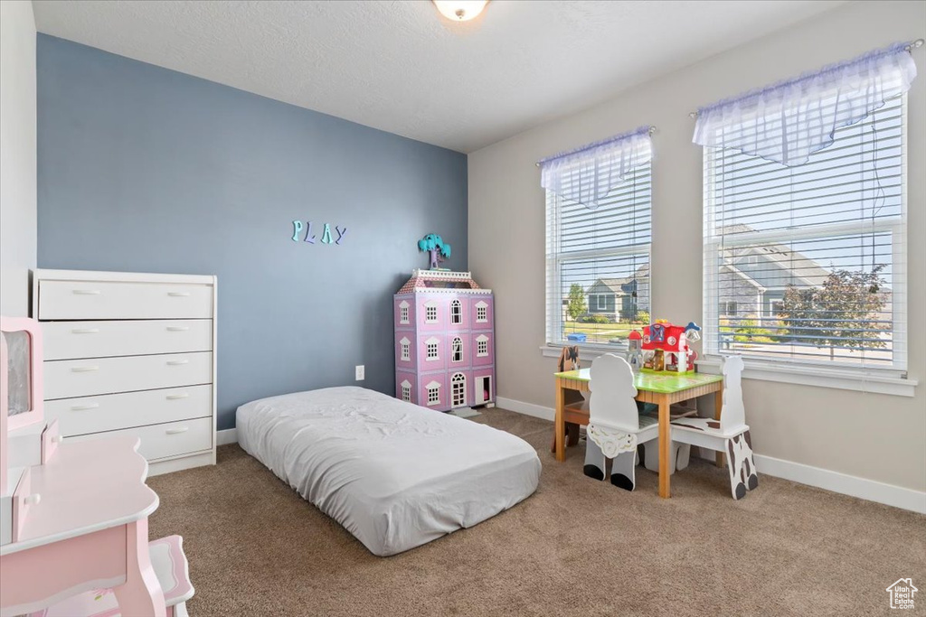 Carpeted bedroom featuring baseboards